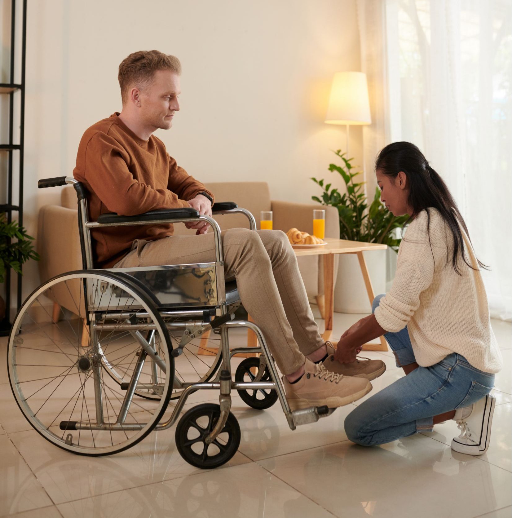 Caregiver helping young man with disability with tying shoe laces SSUCv3H4sIAAAAAAAACpxUuW7cMBDtA+QfFqpDgLdIf0HK9EGK4aFdwlpxIVFODMP/Huo0tbZTpCPfcN4cfDMvX7+cTpWBIdjq4fQy3fI9tO04pB5SiF2G8bcV733nfF8iTz2TuAS8Cyn2AdoSNJDspYOrz2A3tu0Ev87GakiQxsEPRfThMqbk+yFF+5hhsrHcYudECbjew3VIYebdUXDR+HfO0ML1uQRMOM+PbpeYYmkglPXNIW74k+AATC5u7KawrKjFQvLnXPyhmq23P5f7aTPMxuyRTVW1Mi/lj2bGNmgh/y/P5fBr78HZd3Zqwk503+s9yakP7EBe77Qb332vD85YKvaRx+HPSg9ND+GIvLuTDxO4/8WS8buHNl0OLD98vLX+w0pWfRxS8pRQDjWimljEFaZIW2IQx7YxWioO2h3omZVSKTCoqW12sA1GSkqPNCHZ4ik2DX4LvhxeCwH1vvWwDMOaR+UYCGmIRpI1dc6BAVKWauRI7aRotKoV2XKoMMayJkajBnOOuBQcGY0dcpQb5ZxrBFNz/KXw6vF3/vvrrNY1AxhdiIV6n6KFdrjT+a0PNnTnwi2my7wXNjcbxy71z6VCqzbGG5jc/YdTkzn9hl9gGPJzt+HlQOUtFK9FnC6muTsra+XyxE1XwhgWufeUUU2JVLWoyvVyCZlnTmdLcLy1EZx3/xoGIiUhStaMv8lk30GTTRPJ5CfS3h+oT6Zle8DZexHuNvG50rc3snizr67VVhfc+xZbbDWlq/62f8jb4xpy/ceelLtuc+X6vXTn3IIrN1/pWhFjBDhNEQeRR6NpKDKNAsQkp9QS4BybWZorX5jSqLik1ksQSAjlEBca0DR3iACu83SxRoPIXq9/AQAA//8DAHcSfgnHBgAA